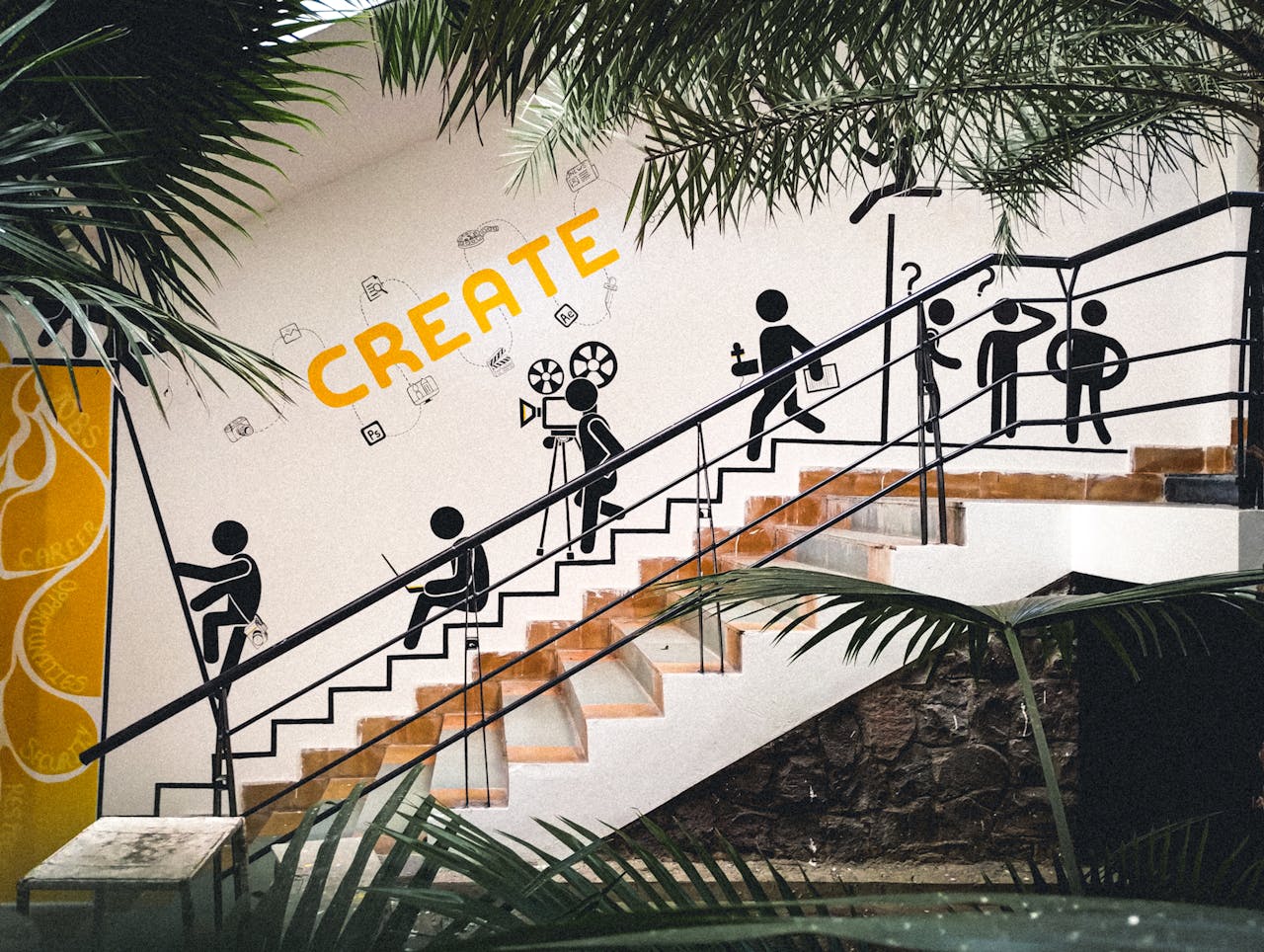 Mural featuring creative stick figures on a staircase with lush greenery.